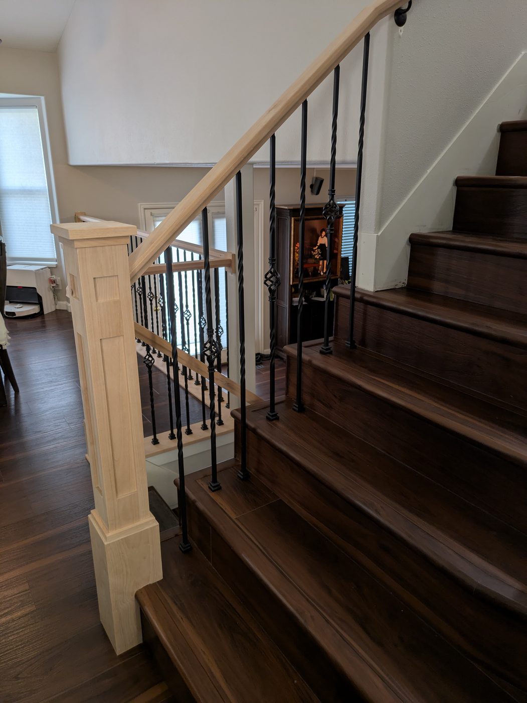 Staircase with iron balusters and wood treads