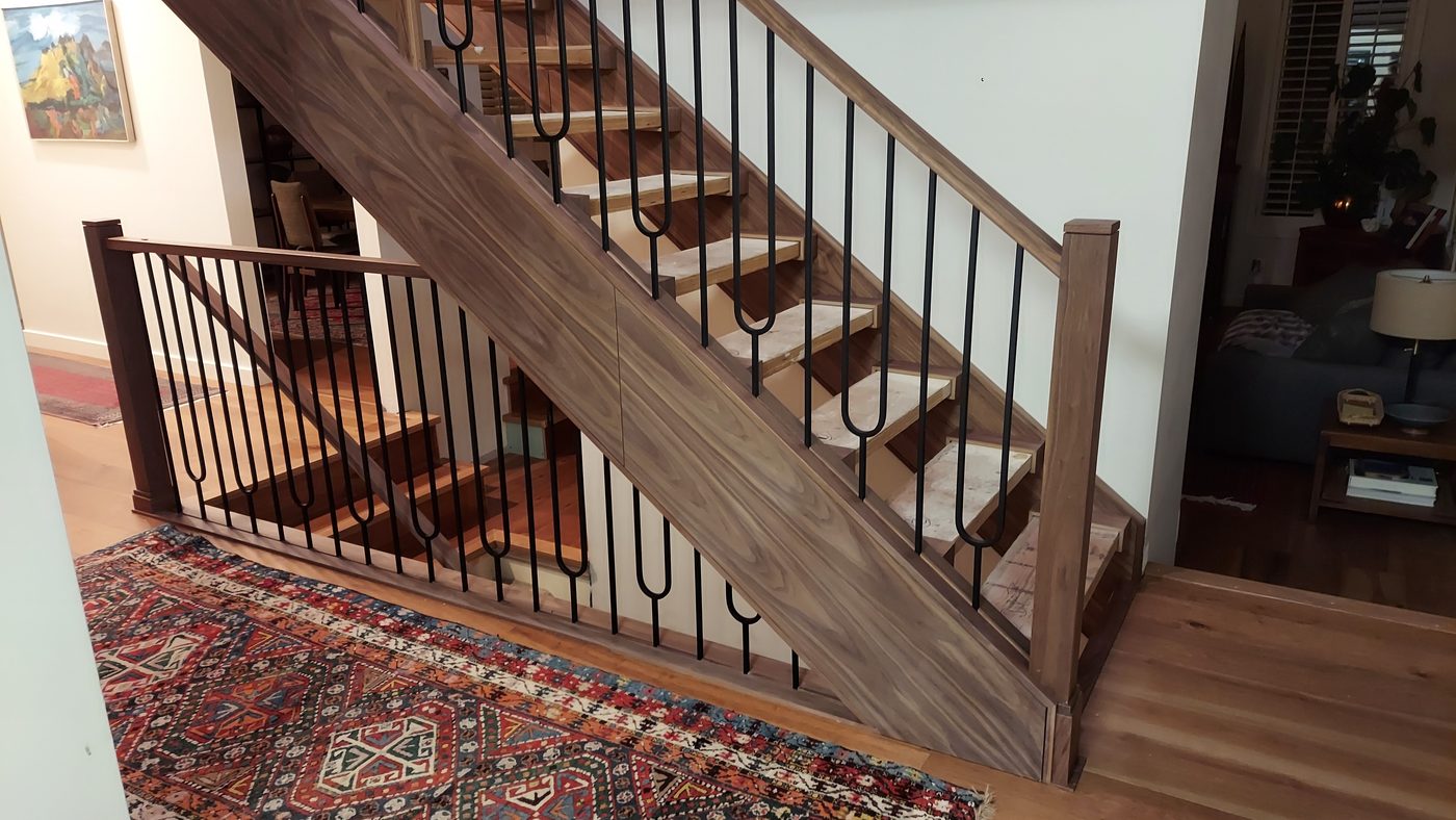Finished staircase with wood and iron railing